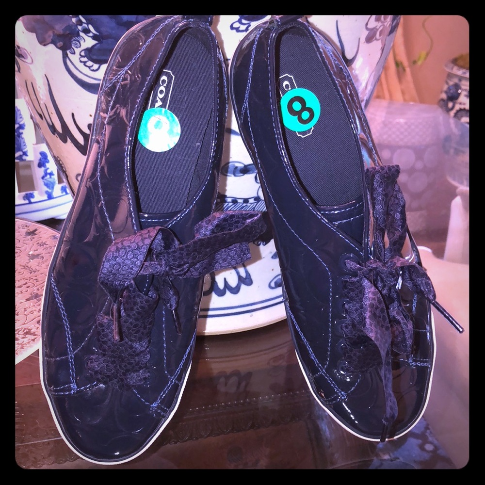 Navy blue Coach sneakers.  Runs a little large. More like a 8.5 or 9